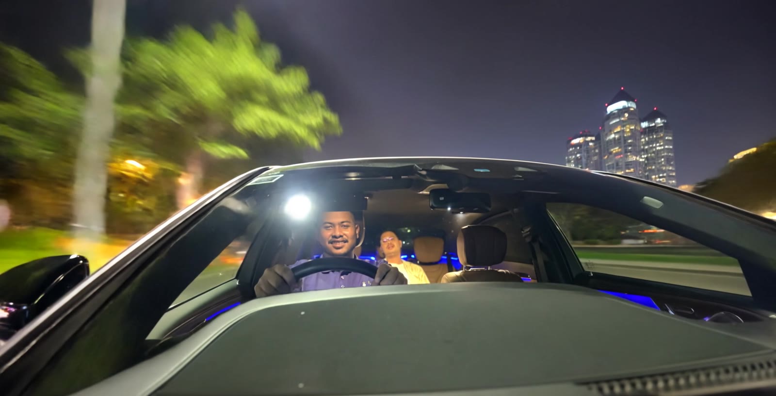Hi Valet driver at the wheel at night, taking a customer home in their own car